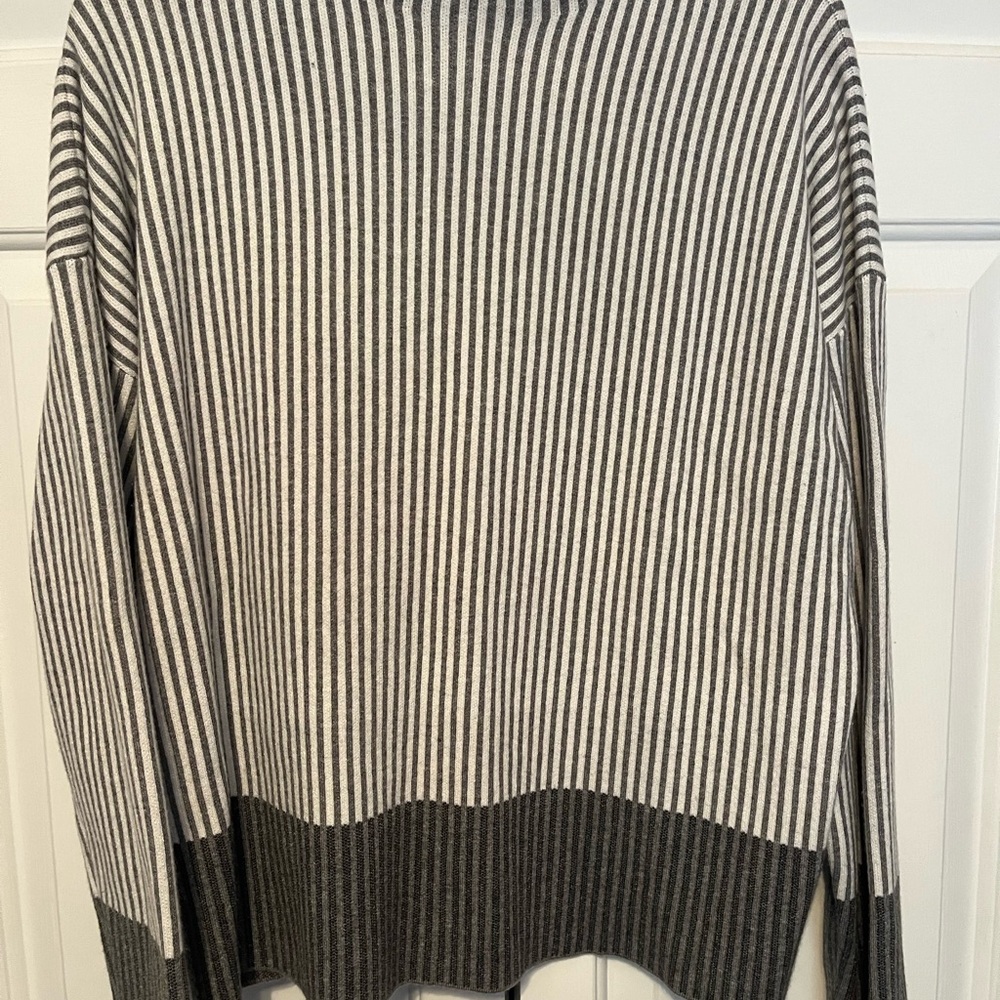Sweater has mock turtleneck
